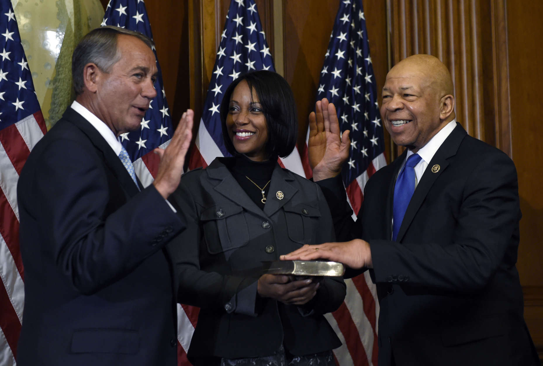 House Speaker John Boehner of Ohio poses for a photo with Rep. Elijah Cummings, D-Md., right, during a re-enactment the House oath-of-office, Tuesday, Jan. 6, 2015, on Capitol Hill in Washington. Cummings' wife Maya Rockeymoore is at center. (AP Photo/Susan Walsh)
