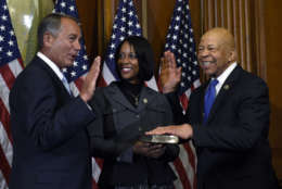 House Speaker John Boehner of Ohio poses for a photo with Rep. Elijah Cummings, D-Md., right, during a re-enactment the House oath-of-office, Tuesday, Jan. 6, 2015, on Capitol Hill in Washington. Cummings' wife Maya Rockeymoore is at center. (AP Photo/Susan Walsh)