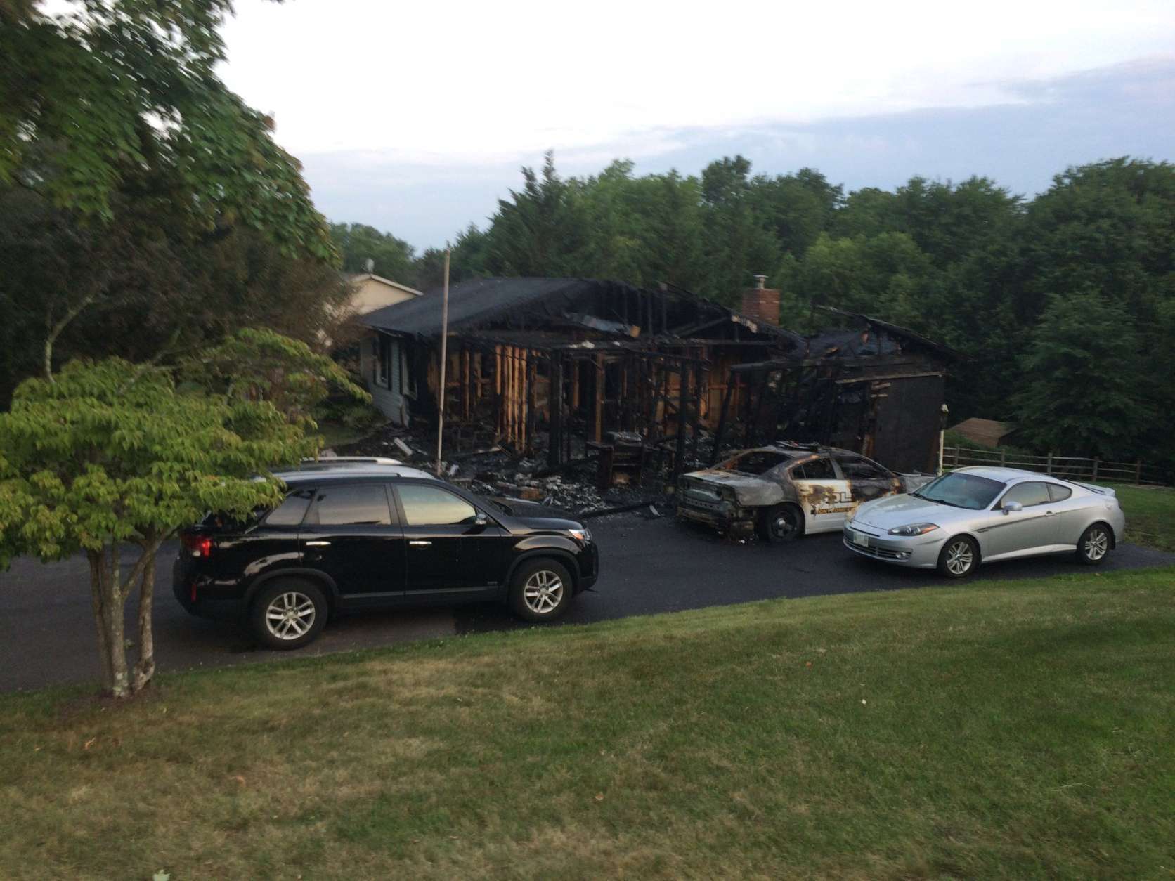 A police cruiser and home were destroyed by fire early Friday morning. (WTOP/Nick Iannelli)