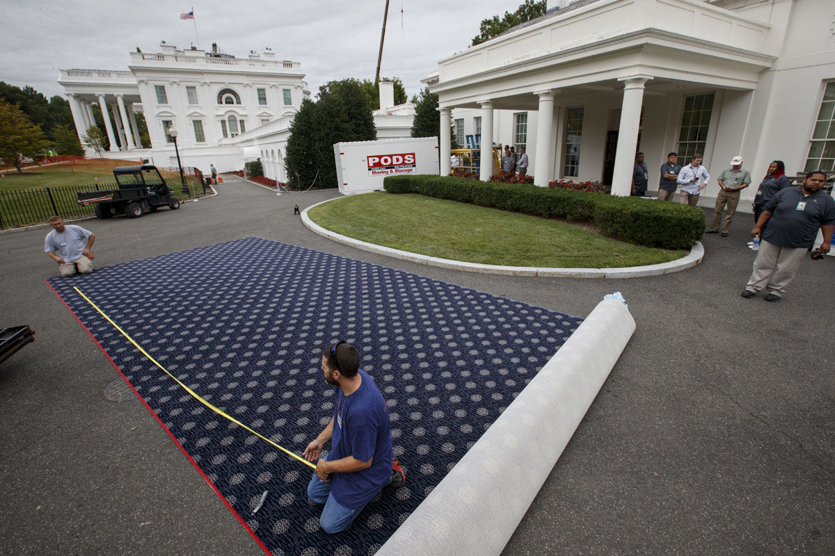 Workmen prepare new carpeting for the West Wing of the White House in Washington, Friday, Aug. 11, 2017, as it undergoes renovations while President Donald Trump is spending time at his golf resort in New Jersey.  (AP Photo/J. Scott Applewhite)