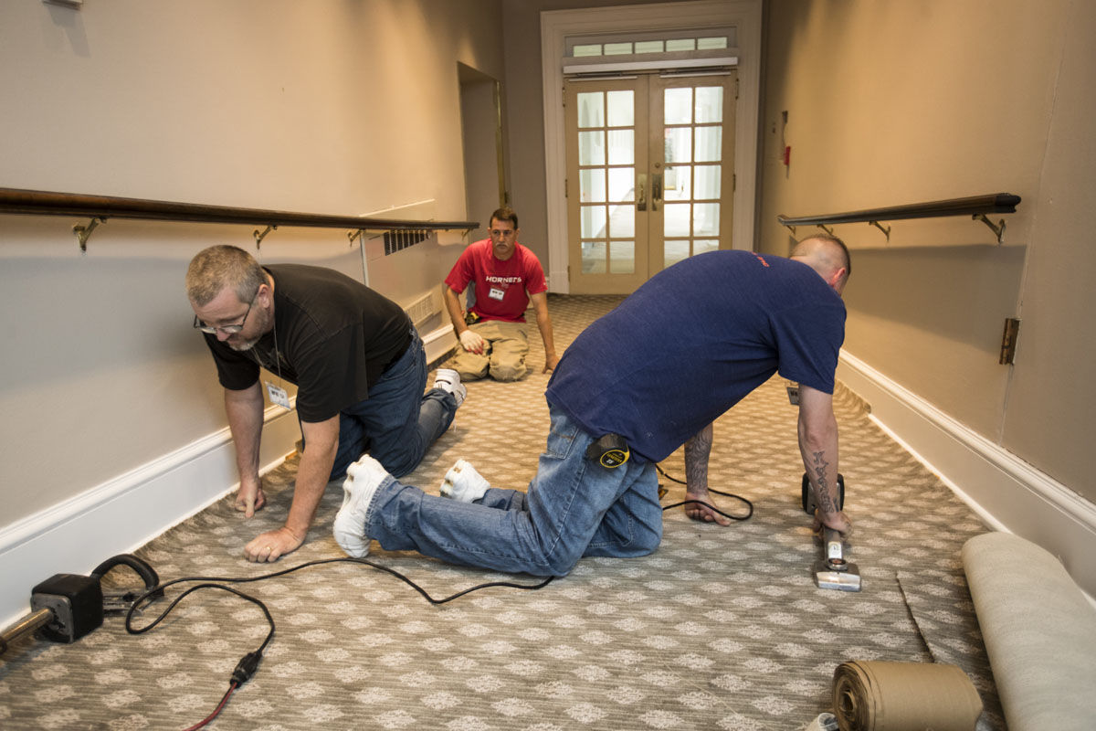 Workmen install new carpet in the West Wing of the White House in Washington,, Friday, Aug. 11, 2017, as it undergoes renovations while President Donald Trump is spending time at his golf resort in New Jersey. (AP Photo/J. Scott Applewhite)