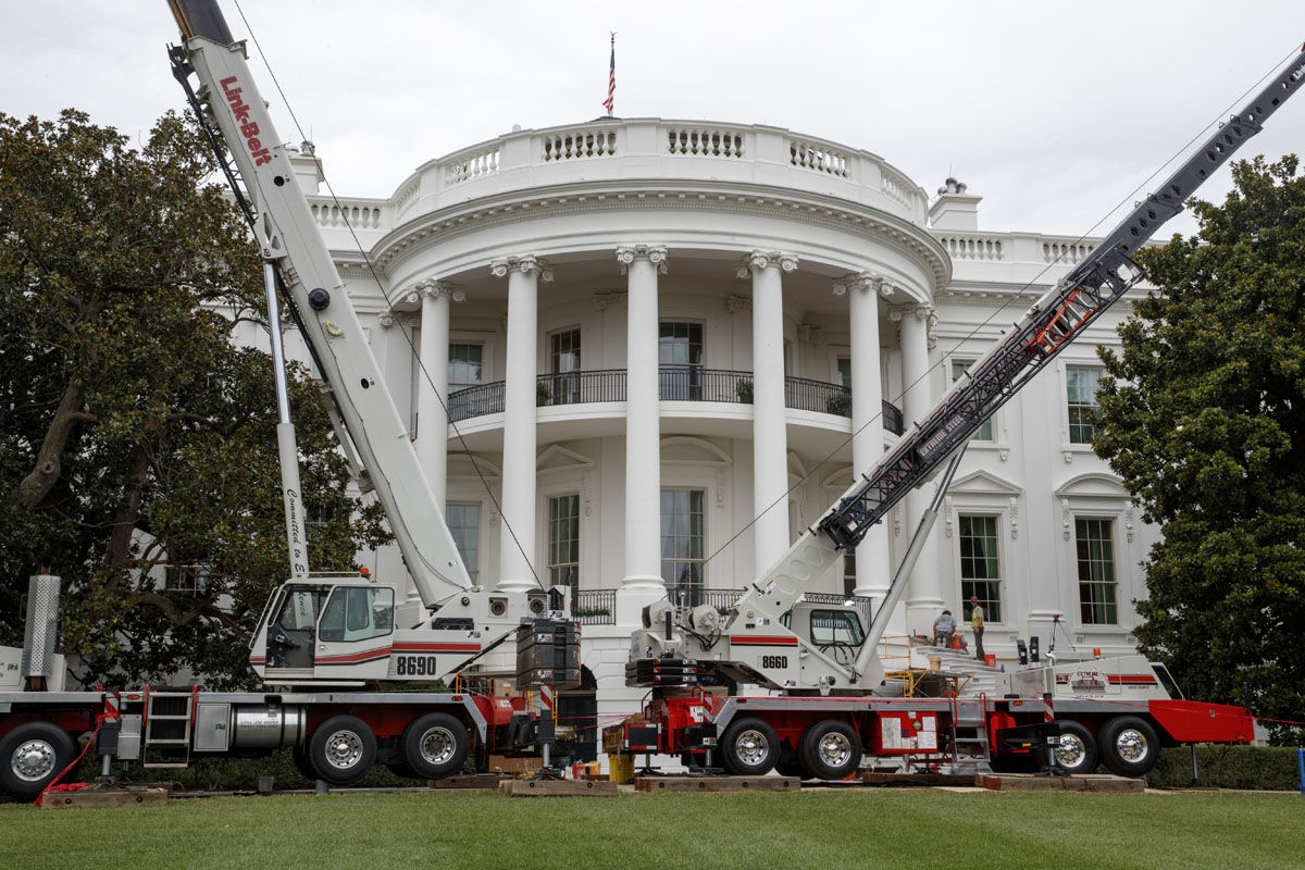 Cranes are positioned in front of the South Portico of the White House in Washington, Friday, Aug. 11, 2017, during renovations while President Donald Trump is spending time at his golf resort in New Jersey. (AP Photo/J. Scott Applewhite)