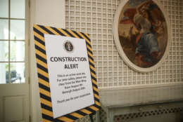A sign in the Palm Room of the White House in Washington alerts visitors as the West Wing is undergoing renovations while President Donald Trump is spending time at his golf resort in New Jersey, Friday, Aug. 11, 2017. (AP Photo/J. Scott Applewhite)