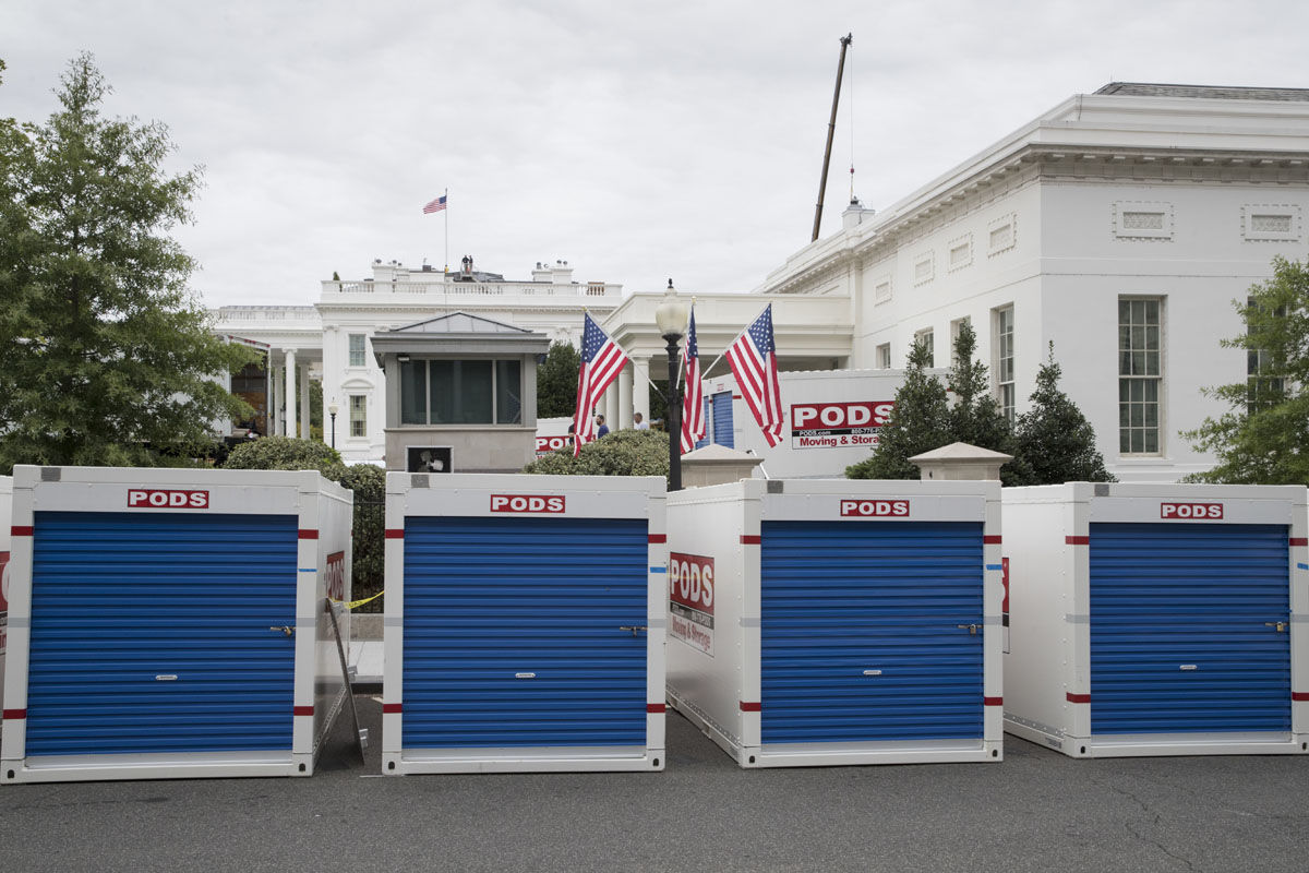 Storage containers line the driveway as the West Wing of the White House in Washington, Friday, Aug. 11, 2017, during renovations while President Donald Trump is spending time at his golf resort in New Jersey. (AP Photo/J. Scott Applewhite)