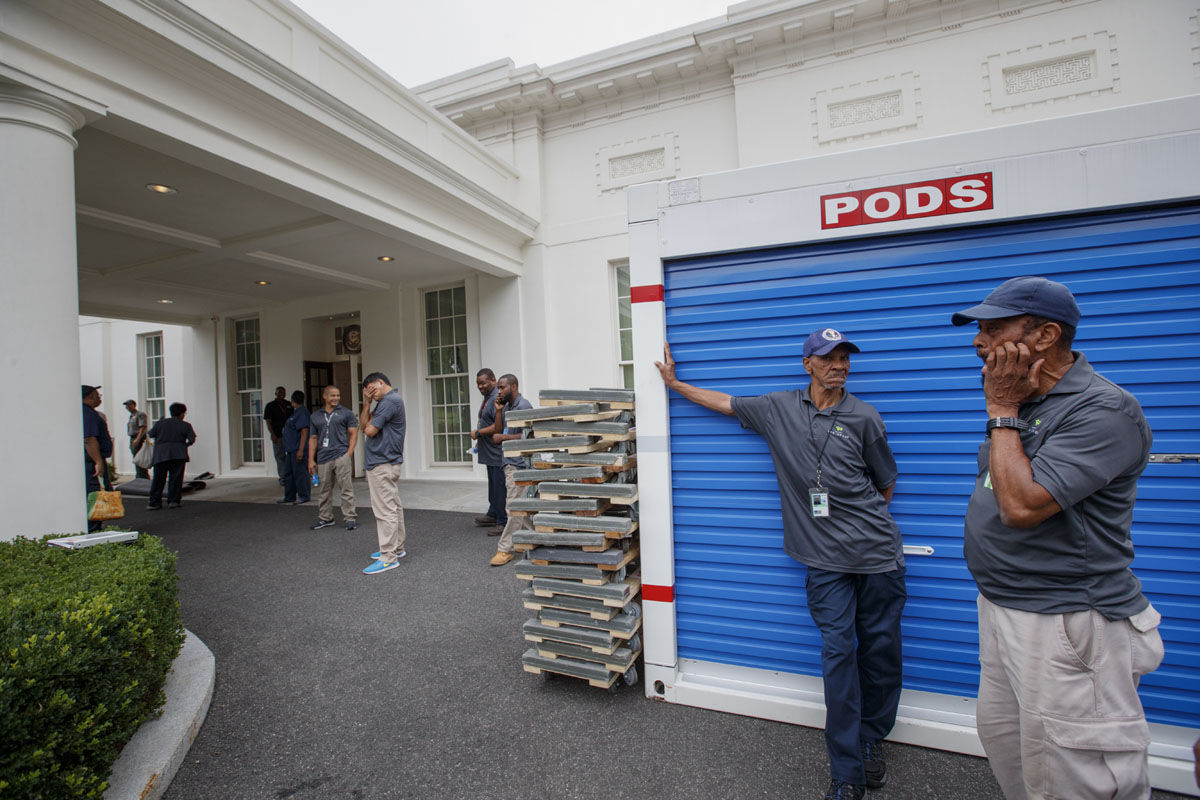 Workmen wait for outside the West Wing of the White House in Washington, Friday, Aug. 11, 2017, during renovations while President Donald Trump is spending time at his golf resort in New Jersey. (AP Photo/J. Scott Applewhite)