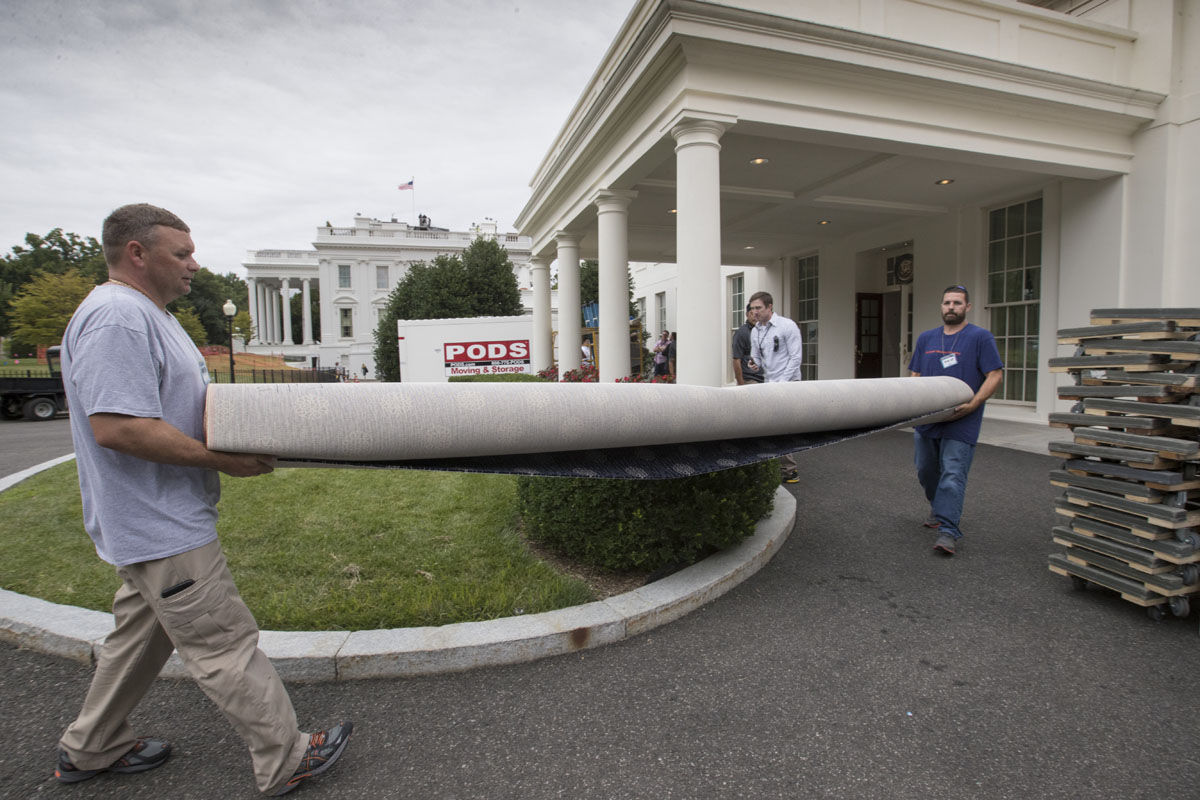 Workmen carry new carpeting into the West Wing of the White House in Washington, Friday, Aug. 11, 2017, as it undergoes renovations while President Donald Trump is spending time at his golf resort in New Jersey. (AP Photo/J. Scott Applewhite)