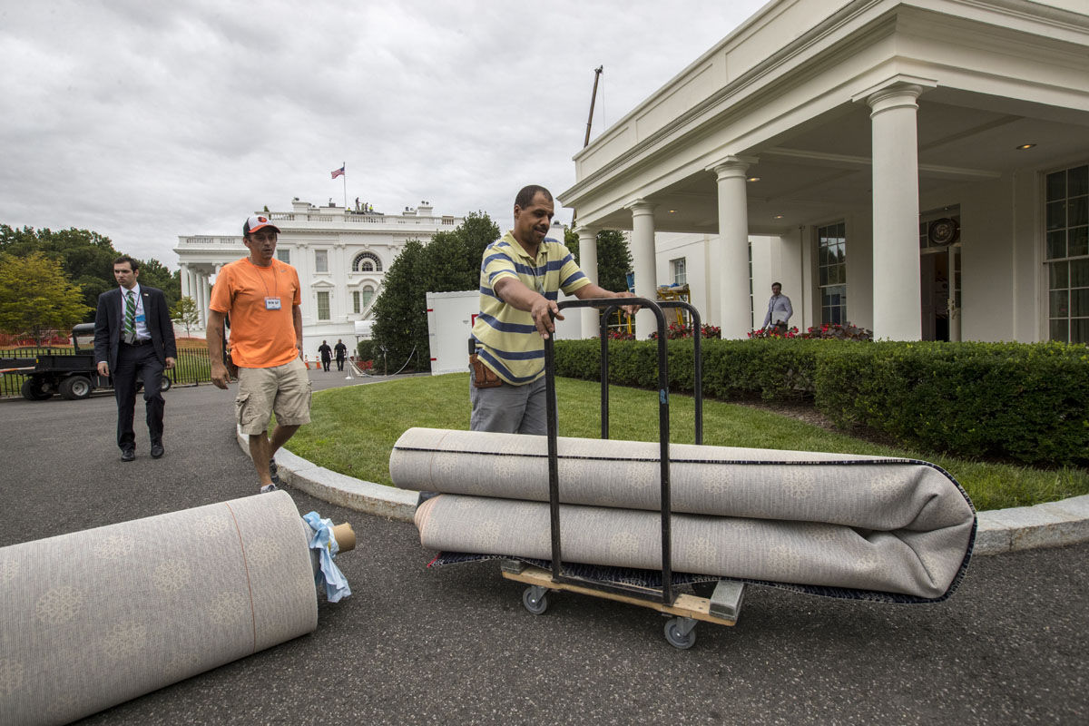 Workmen move new carpeting into the West Wing of the White House in Washington, Friday, Aug. 11, 2017, as it undergoes renovations while President Donald Trump is spending time at his golf resort in New Jersey. (AP Photo/J. Scott Applewhite)
