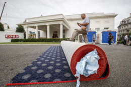 Workmen prepare new carpeting for the West Wing of the White House in Washington, Friday, Aug. 11, 2017, as it undergoes renovations while President Donald Trump is spending time at his golf resort in New Jersey. (AP Photo/J. Scott Applewhite)