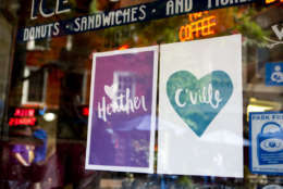 Signs hang in the window of a cafe in support of Heather Heyer at the Downtown Mall in Charlottesville, Va. Wednesday, Aug. 16, 2017 in Charlottesville, Va. Heyer was killed Saturday, when a car rammed into a crowd of people protesting a white nationalist rally.   (AP Photo/Julia Rendleman)