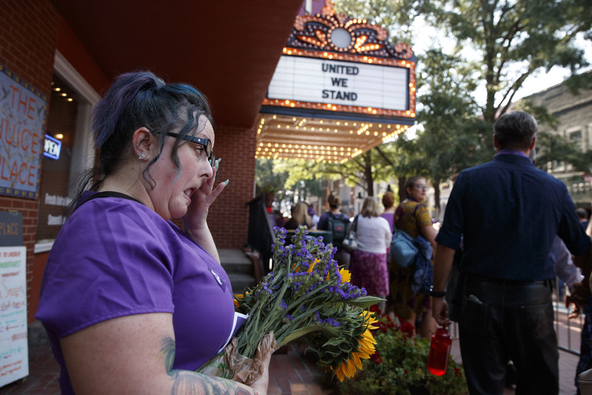 Cynthia Sullivan of Charlottesville, Va., stands in line for a memorial service for Heather Heyer, who was killed during a white nationalist rally, Wednesday, Aug. 16, 2017, in Charlottesville, Va. (AP Photo/Evan Vucci)