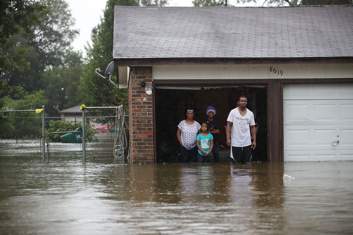 HOUSTON, TX - AUGUST 28:  People wait to be rescued from their  flooded homes after the area was inundated with flooding from Hurricane Harvey on August 28, 2017 in Houston, Texas. Harvey, which made landfall north of Corpus Christi late Friday evening, is expected to dump upwards to 40 inches of rain in Texas over the next couple of days.  (Photo by Joe Raedle/Getty Images)