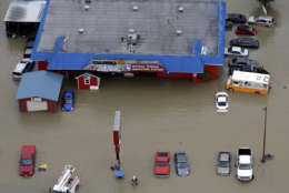 Businesses and cars are flooded near the Addicks Reservoir as floodwaters from Tropical Storm Harvey rise Tuesday, Aug. 29, 2017, in Houston. (AP Photo/David J. Phillip)