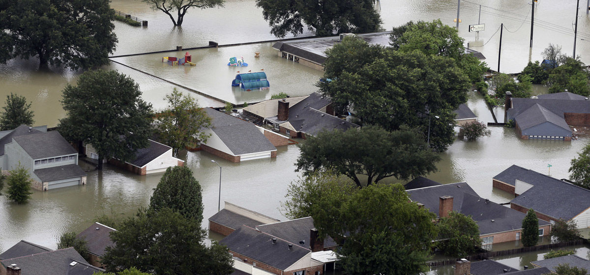 Homes are flooded near the Addicks Reservoir as floodwaters from Tropical Storm Harvey rise Tuesday, Aug. 29, 2017, in Houston. (AP Photo/David J. Phillip)