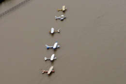 Airplanes sit at a flooded airport near the Addicks Reservoir as floodwaters from Tropical Storm Harvey rise Tuesday, Aug. 29, 2017, in Houston. (AP Photo/David J. Phillip)