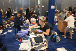 HOUSTON, TX - AUGUST 29:  Volunteers sort through donated clothing for the people that have taken shelter at the George R. Brown Convention Center after flood waters from Hurricane Harvey inundated the city on August 29, 2017 in Houston, Texas. The evacuation center which is overcapacity has already received more than 9,000 evacuees with more arriving.  (Photo by Joe Raedle/Getty Images)