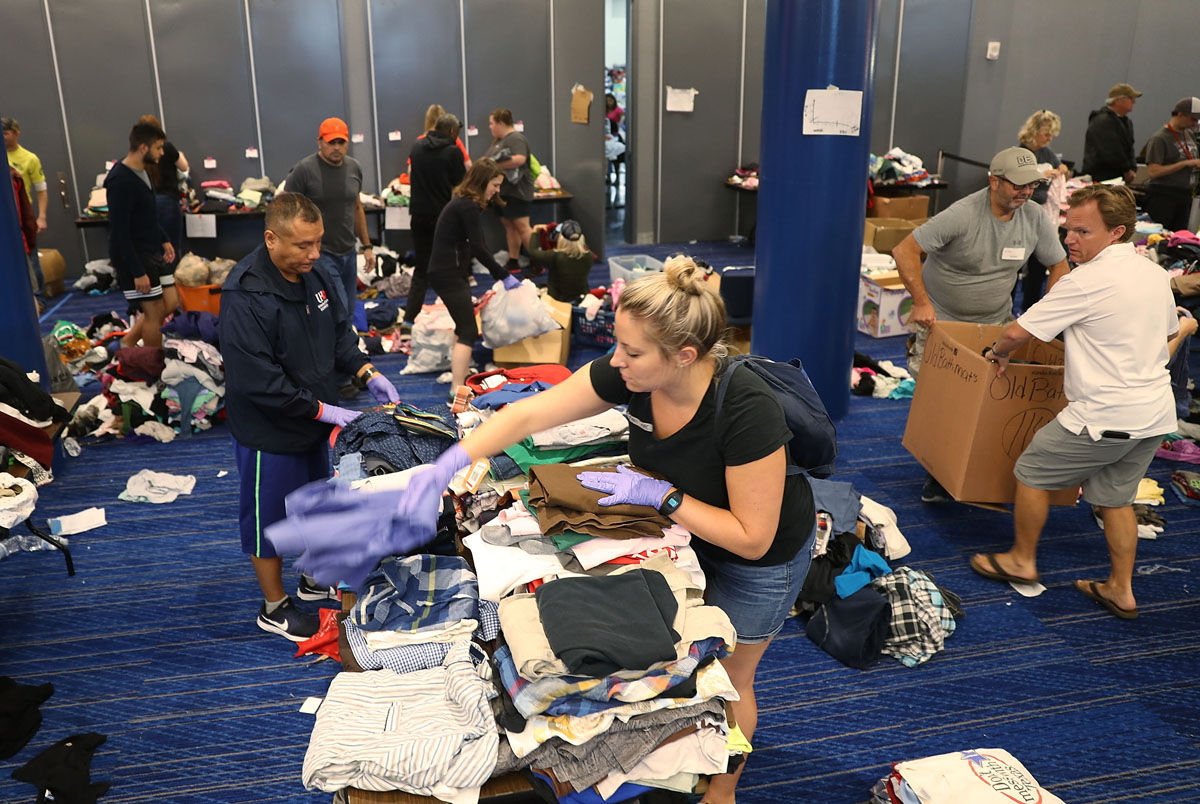 HOUSTON, TX - AUGUST 29:  Volunteers sort through donated clothing for the people that have taken shelter at the George R. Brown Convention Center after flood waters from Hurricane Harvey inundated the city on August 29, 2017 in Houston, Texas. The evacuation center which is overcapacity has already received more than 9,000 evacuees with more arriving.  (Photo by Joe Raedle/Getty Images)