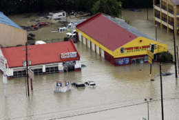 Businesses and cars are flooded near the Addicks Reservoir as floodwaters from Tropical Storm Harvey rise Tuesday, Aug. 29, 2017, in Houston. (AP Photo/David J. Phillip)
