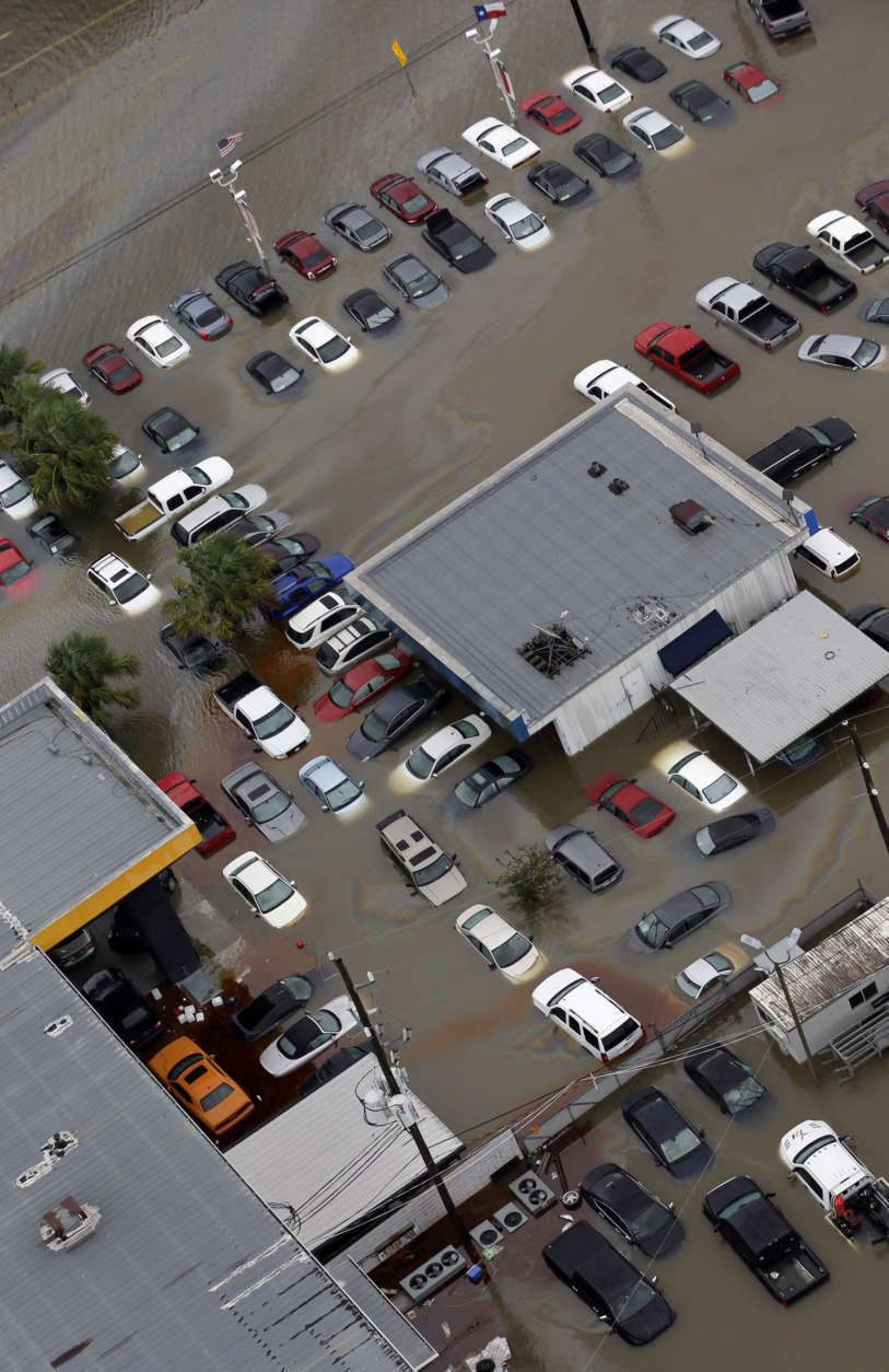 Cars and businesses are flooded near the Addicks Reservoir as floodwaters from Tropical Storm Harvey rise Tuesday, Aug. 29, 2017, in Houston. (AP Photo/David J. Phillip)