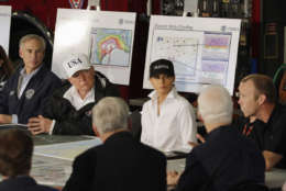 President Donald Trump, flanked by Texas Gov. Greg Abbott and first lady Melania Trump listens during a briefing on Harvey relief efforts, Tuesday, August 29, 2017, at Firehouse 5 in Corpus Christi, Texas. (AP Photo/Evan Vucci)