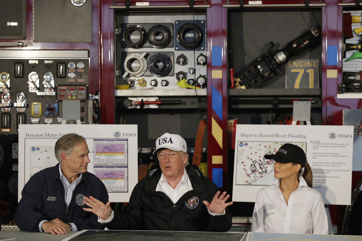 President Donald Trump, flanked by Texas Gov. Greg Abbott and first lady Melania Trump speaks during a briefing on Harvey relief efforts, Tuesday, Aug. 29, 2017, at Firehouse 5 in Corpus Christi, Texas. (AP Photo/Evan Vucci)