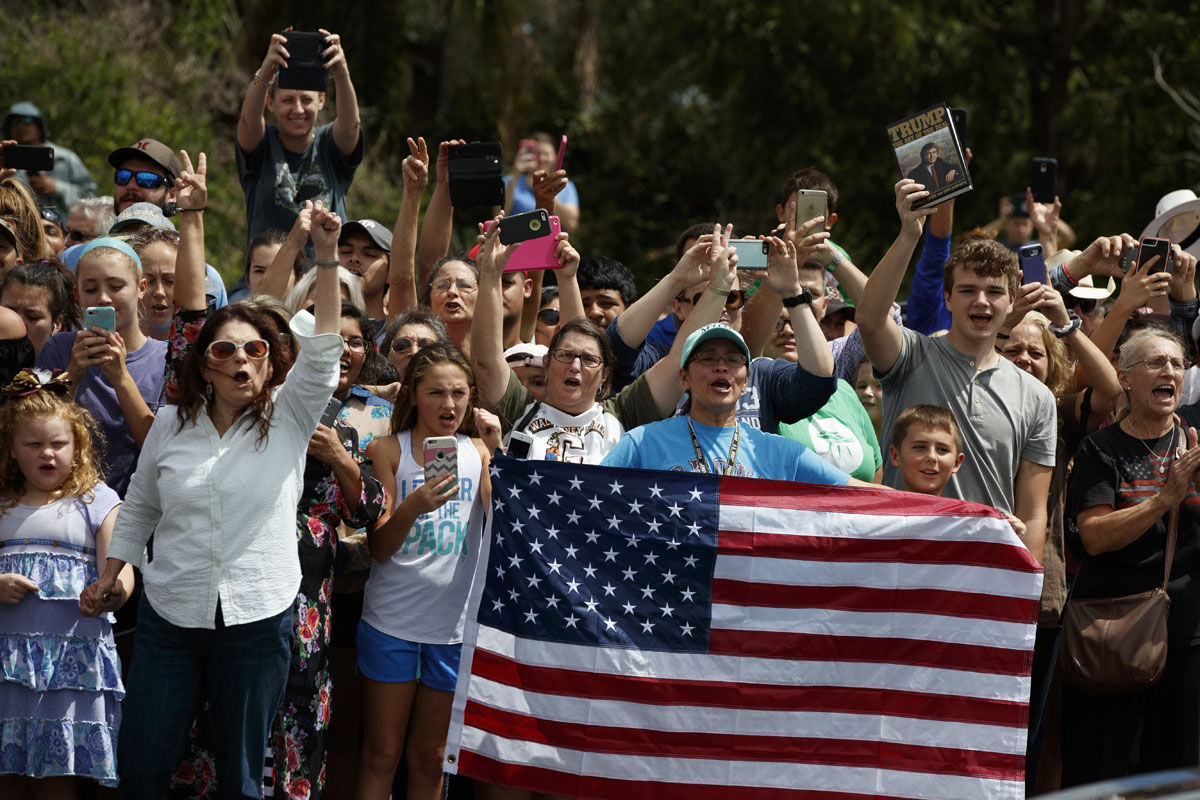 Supporters of President Donald Trump cheer outside Firehouse 5 in Corpus Christi, Texas, Tuesday, Aug. 29, 2017, as the president received a briefing on Harvey relief efforts. (AP Photo/Evan Vucci)