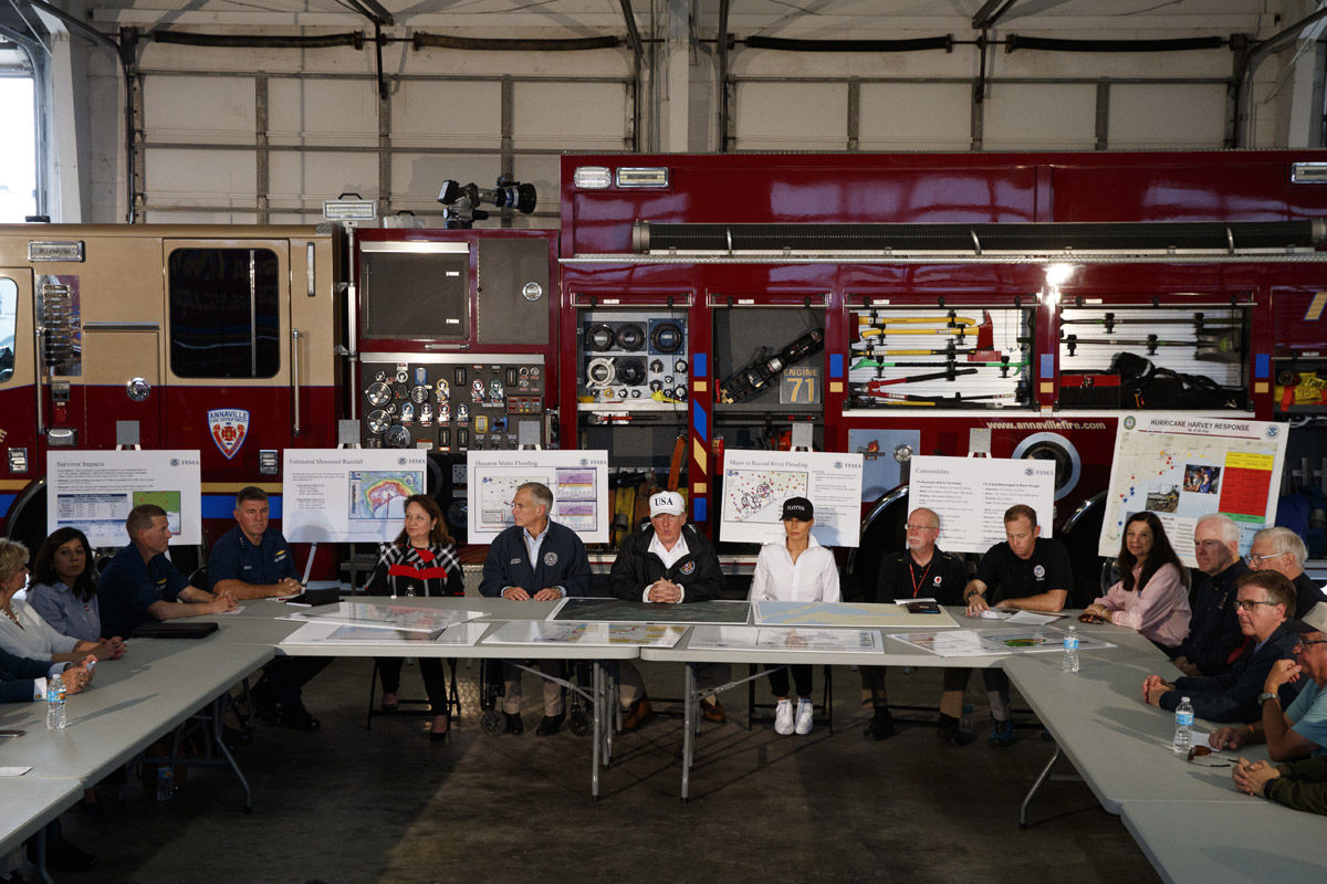 President Donald Trump, accompanied by, from left, center table, acting Homeland Security Secretary Elaine Duke, Texas Gov. Greg Abbott and first lady Melania Trump, participates in a briefing on Harvey relief efforts, Tuesday, Aug. 29, 2017, in Corpus Christi, Texas. (AP Photo/Evan Vucci)