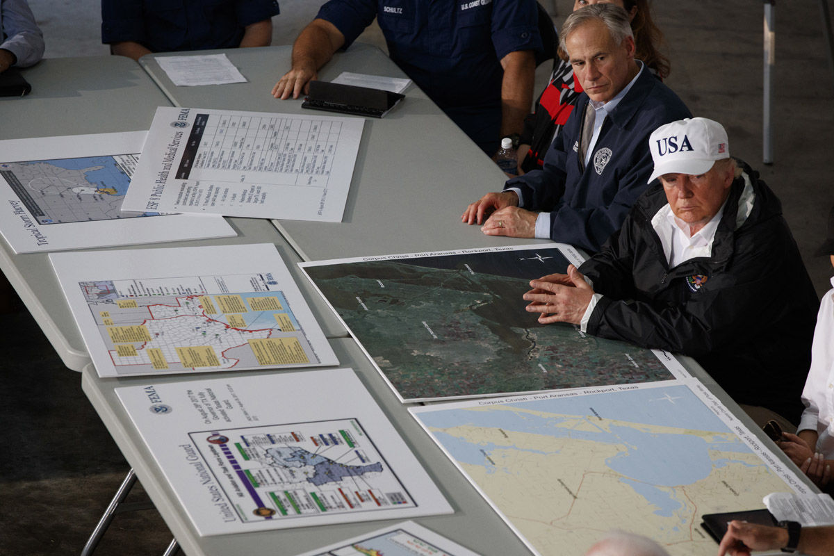 Texas Gov. Greg Abbot and President Donald Trump listen during a briefing on Harvey relief efforts, Tuesday, Aug. 29, 2017, in Corpus Christi, Texas. (AP Photo/Evan Vucci)