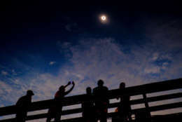 ISLE OF PALMS, SC - AUGUST 21:   Solar eclipse watchers were ecstatic as the clouds broke minutes before totality during the total solar eclipse from the one of last vantage points where totality will be visible on August 21, 2017 in Isle of Palms, S.C.. It's been 99 years since a total solar eclipse crossed the country from the Pacific to the Atlantic. The total solar eclipse on June 8, 1918, crossed the States from Washington to Florida.  (Photo by Pete Marovich/Getty Images)
