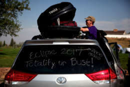 CASPER, WY - AUGUST 21:  Brian Marriott of Boston, Massachusetts looks in a storage container on top of his car before watching the solar eclipse at South Mike Sedar Park on August 21, 2017 in Casper, Wyoming.  Millions of people have flocked to areas of the U.S. that are in the "path of totality" in order to experience a total solar eclipse. During the event, the moon will pass in between the sun and the Earth, appearing to block the sun. (Photo by Justin Sullivan/Getty Images)
