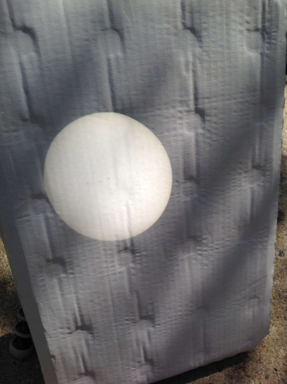 Before the eclipse in Brevard, North Carolina, a projected image of the sun from a telescope onto white cardboard. The dark spots are sun spots. (Courtesy Mike Stinneford)