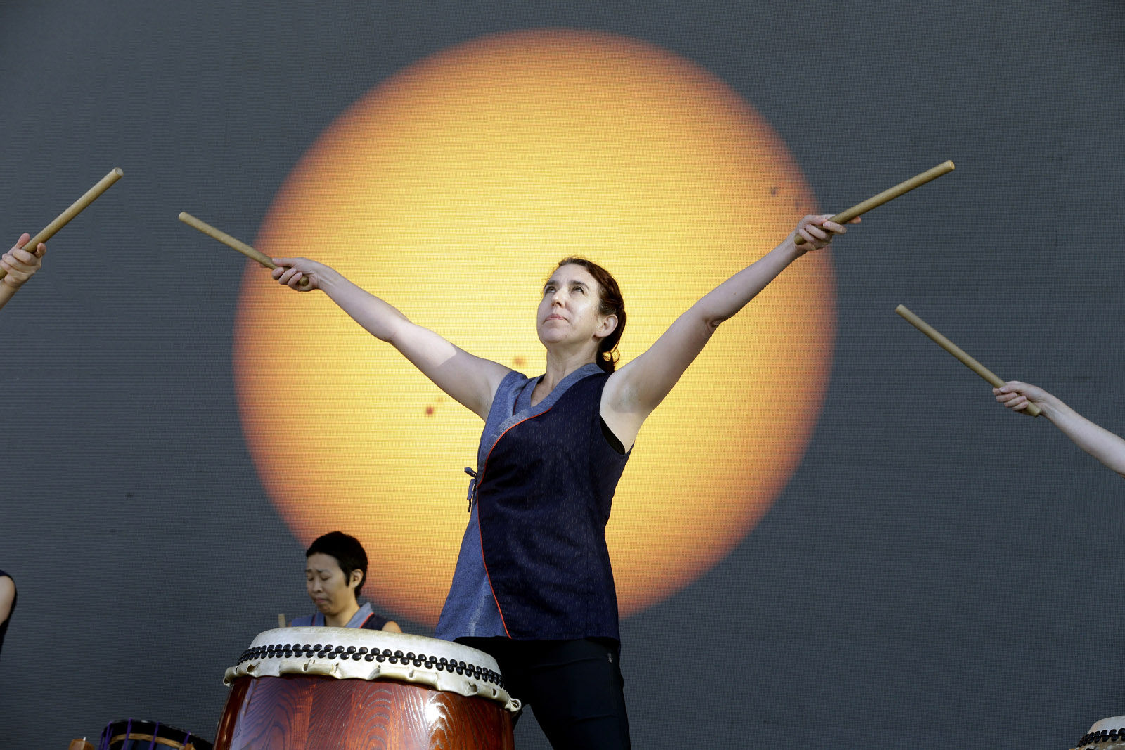 Portland Taiko drummer Karen Tingey performs in front of a live video shot of the sun to introduce the solar eclipse from Salem, Ore., Monday, Aug. 21, 2017. (AP Photo/Don Ryan)