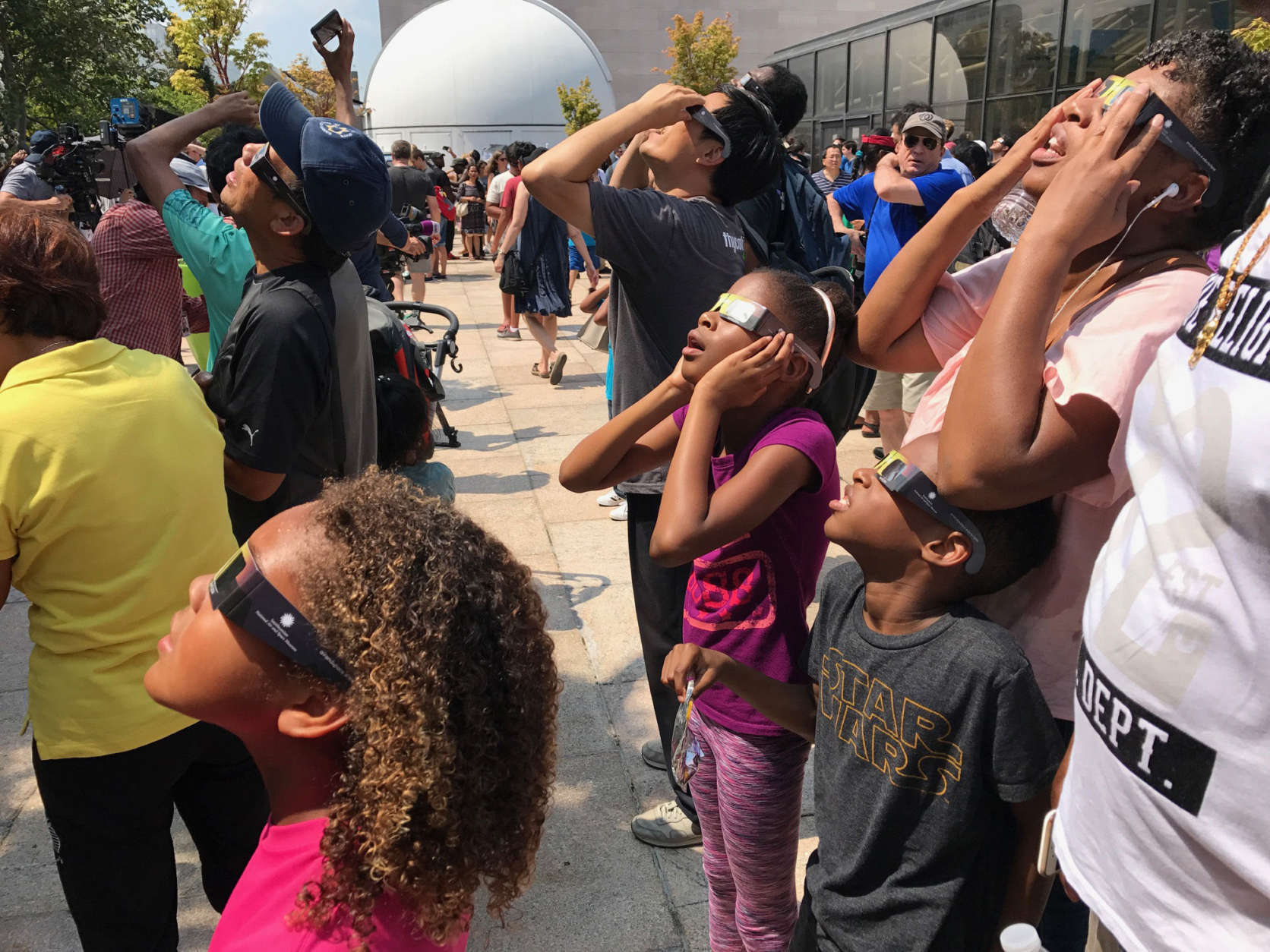 People look up to the sky for a glimpse of the eclipse, they won't get another chance to see something like this for another seven years. (WTOP/Megan Cloherty)