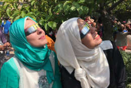 Sara and Hadeer waited 20 minutes for their glasses at the Air and Space Museum so they could safely watch the eclipse. (WTOP/Megan Cloherty)