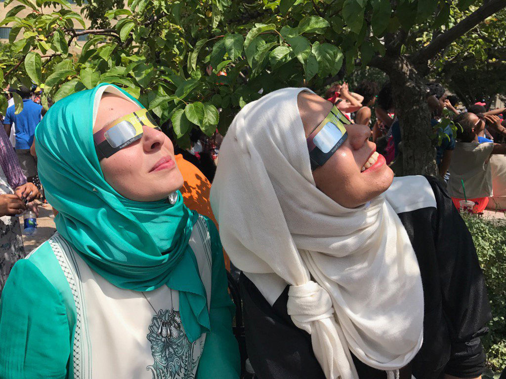 Sara and Hadeer waited 20 minutes for their glasses at the Air and Space Museum so they could safely watch the eclipse. (WTOP/Megan Cloherty)