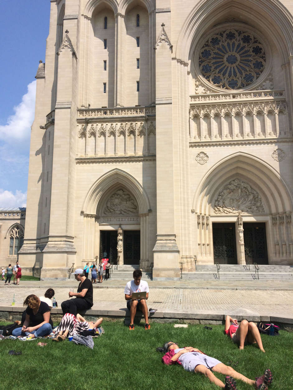 People outside of the National Cathedral ahead of the eclipse. (WTOP/Abigail Constantino)