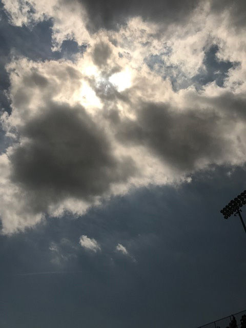 The sun peeks through the clouds after the eclipse in Carbondale, Illinois. (WTOP/Steve Dresner)
