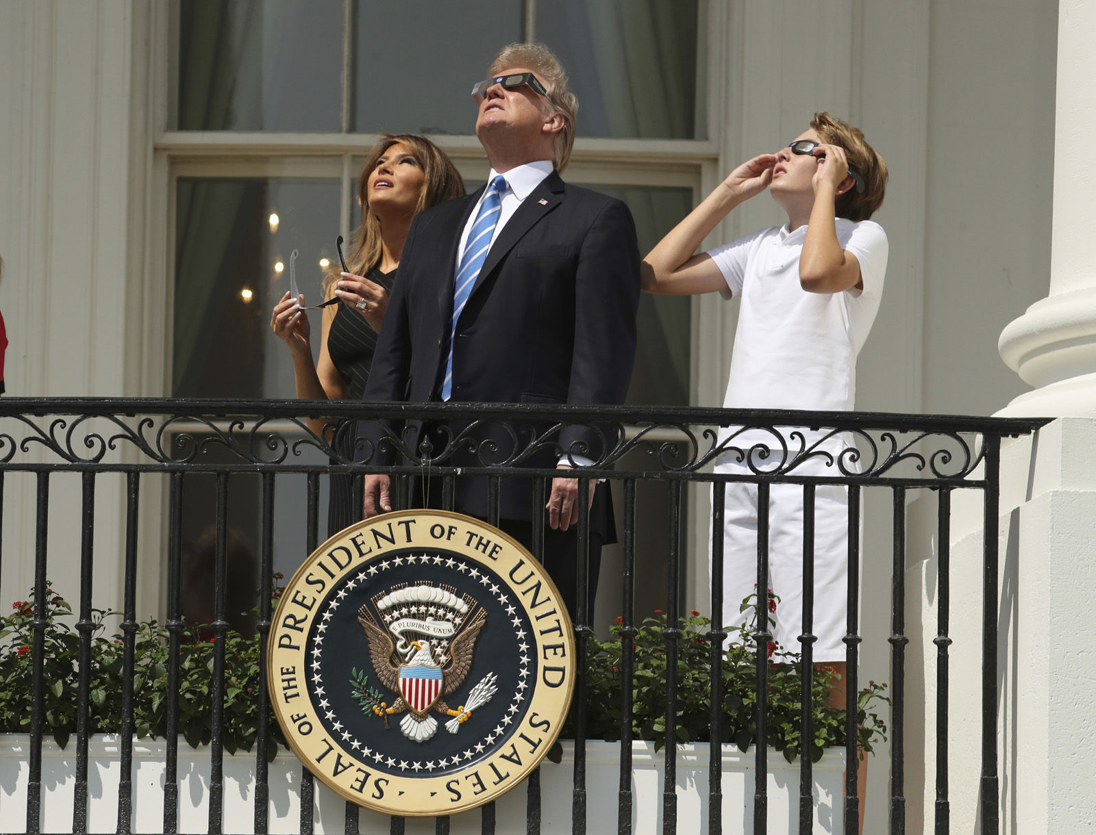 President Donald Trump, first lady Melania Trump and their son Barron watch the solar eclipse, Monday, Aug. 21, 2017, at the White House in Washington.  (AP Andrew Harnik)