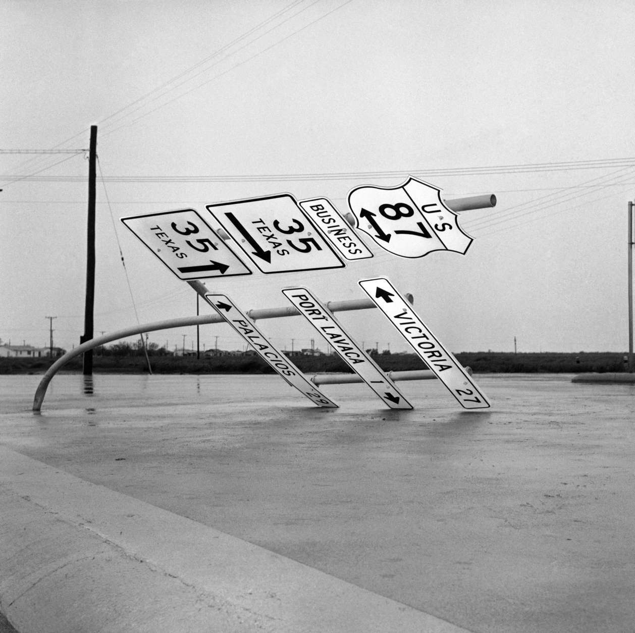 Fierce winds accompanying hurricane Carla bent this heavy steel pole holding road signs outside Port Lavaca, Texas on Sept. 12, 1961. The hurricane caused extensive damage in this coastal city. (AP Photo/Ted Powers)