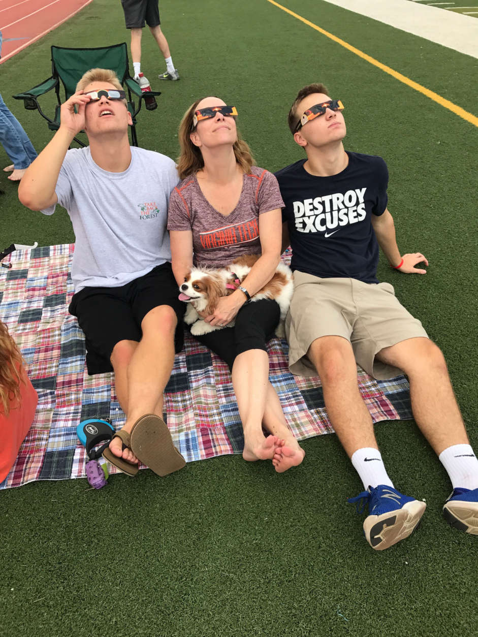 A family gazes skyward during the eclipse. (Courtesy Kyle Cooper)