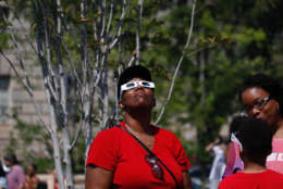 People in D.C. take in the solar eclipse. (WTOP/Kate Ryan)
