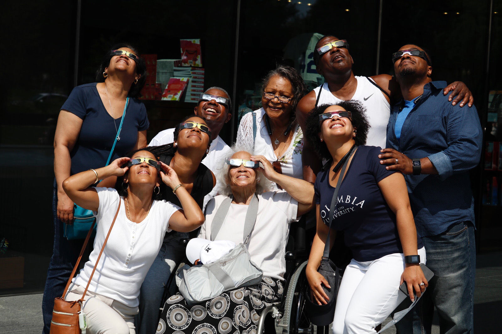 Martha Harris and her family, in from New York City, check out the solar eclipse. (WTOP/Kate Ryan)