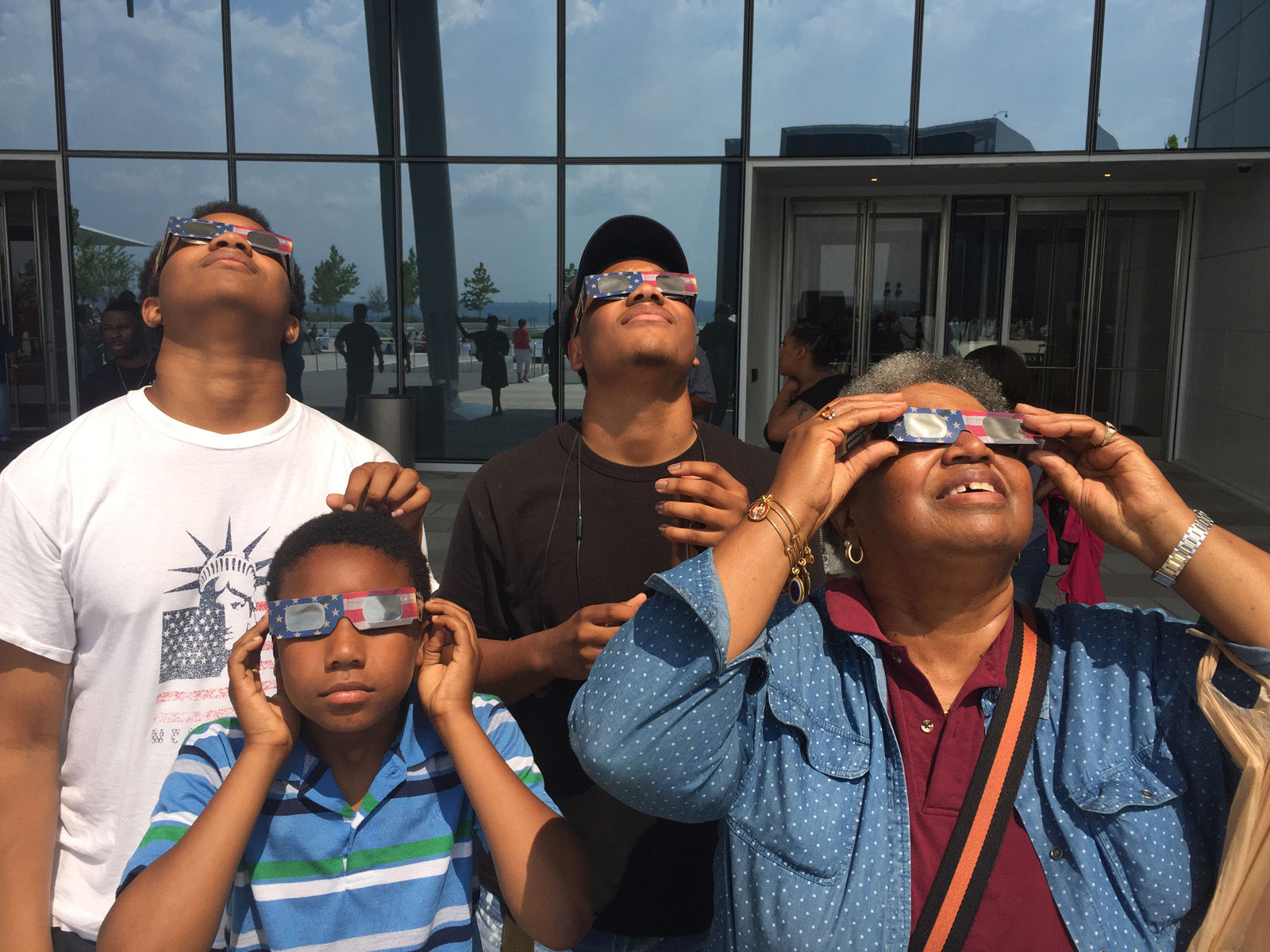 A grandmother and her three grandsons look up at the solar eclipse. (Courtesy Shannon Finney Photography)