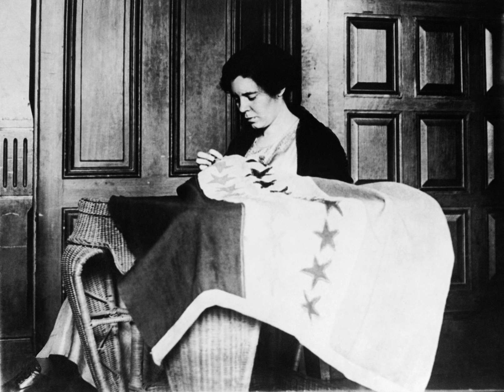 Alice Paul, Chairman of the Nation Women's Party, takes up needle &amp; thread to put the last stitch in the suffrage banner which now has 36 stars representing the 36 states which ratified the suffrage amendment. circa 1932. (AP Photo)