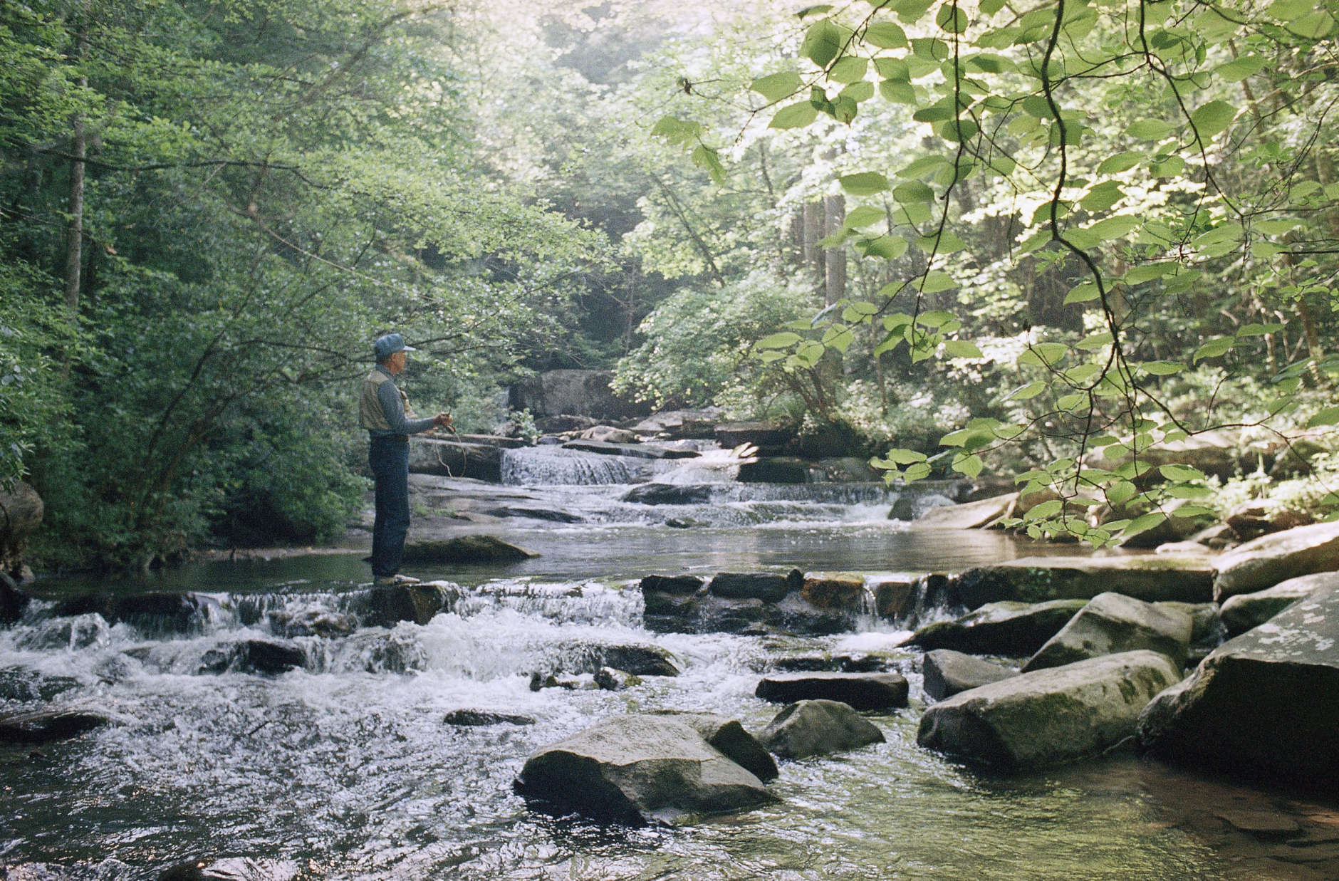 Former President Jimmy Carter fishes in the waters in front of his mountain cabin at Ellijay, Georgia, in May 1988. (AP Photo/Joe Holloway, Jr.)