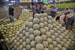 Vendors sort melons at Kramat Jati Market in Jakarta, Indonesia, Tuesday, May 10, 2016. Kramat Jati is the largest traditional market in the capital. (AP Photo/Tatan Syuflana)