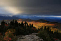In this Tuesday, Oct. 4, 2016 photo, fall foliage colors a line of mountains in Chatham, N. H., as unsettled weather begins to clear. The state's mountain regions are approaching their peak autumn colors. (AP Photo/Robert F. Bukaty)