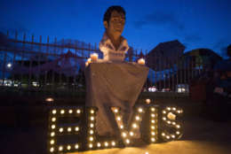 A street memorial is lit during a candlelight vigil for Elvis Presley in front of Graceland, Presley's Memphis home, on Tuesday, Aug. 15, 2017, in Memphis, Tenn. Fans from around the world are at Graceland for the 40th anniversary of his death. Presley died Aug. 16, 1977. (AP Photo/Brandon Dill)