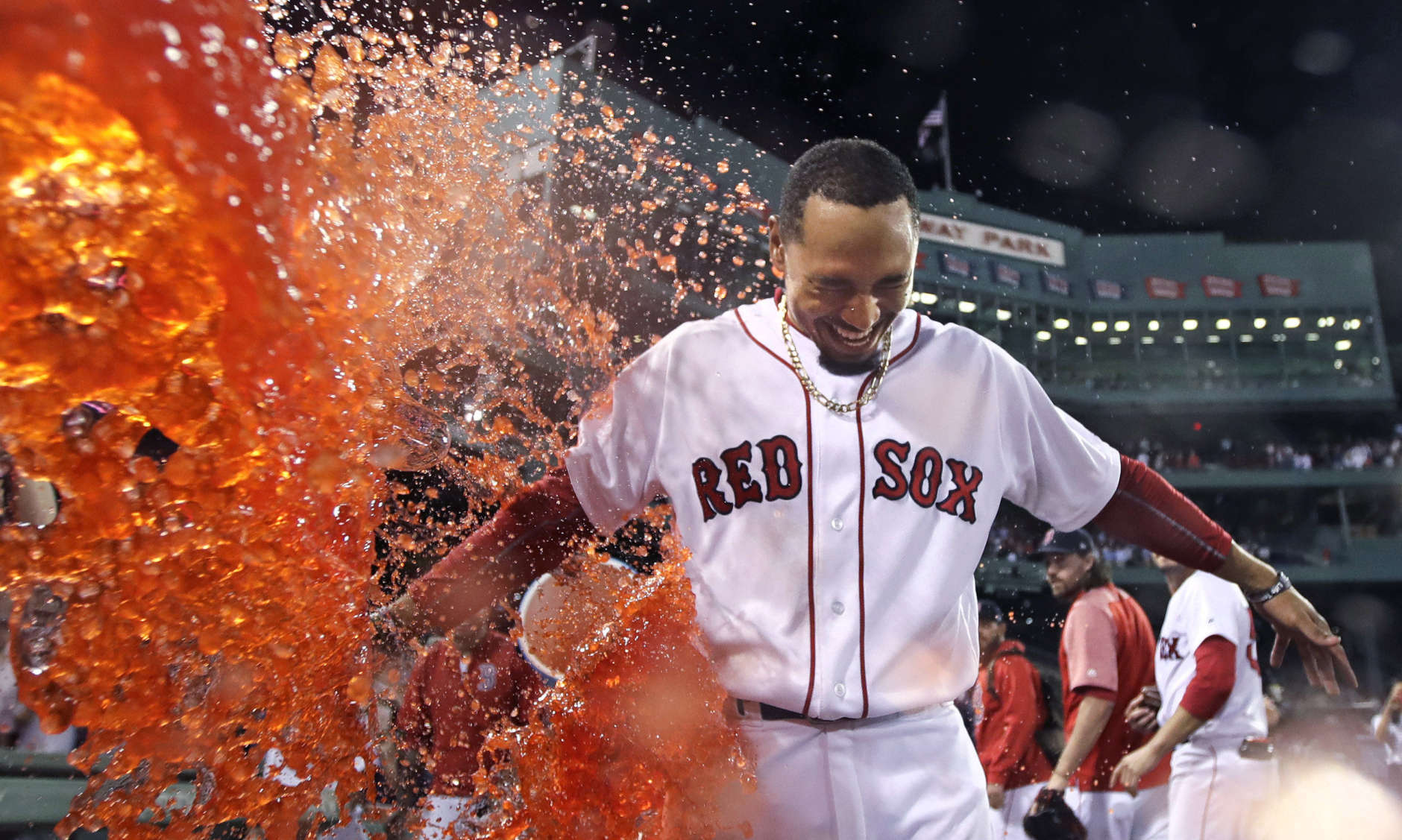 Boston Red Sox's Mookie Betts is doused after his walk-off two-run double during the ninth inning of a baseball game against the St. Louis Cardinals in Boston, Wednesday, Aug. 16, 2017. The Red Sox won 5-4. (AP Photo/Charles Krupa)