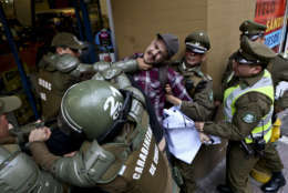 A man is detained by national police outside the Argentina consulate during a protest demanding information on the whereabouts of missing activist Santiago Maldonado, in Santiago, Chile, Thursday, Aug. 17, 2017. Maldonado’s family says he went missing Aug. 1, when he was taking part in a protest supporting the land claims by the indigenous Mapuche community. They say border police detained him when he was blocking a road with other protesters in Chubut province, about 1,100 miles (1,800 kilometers) southeast of Argentina’s capital. (AP Photo/Esteban Felix)