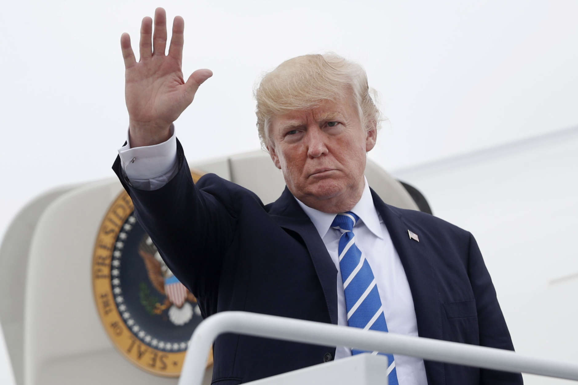 President Donald Trump waves as he boards Air Force One at Hagerstown Regional Airport in Hagerstown, Md., Friday, Aug. 18, 2017, following a national security meeting at Camp David. (AP Photo/Pablo Martinez Monsivais)